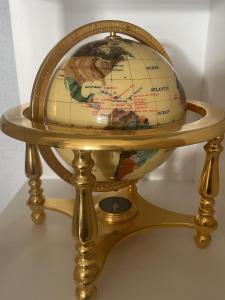 a globe on a gold stand on a table at Park Crescent Hotel in Manchester