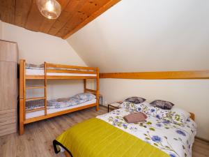 a bedroom with a bed and a bunk bed at Gazdówka na Mosornym Groniu in Zawoja