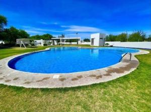 a large blue swimming pool in the grass at Casa Denali in Aguascalientes