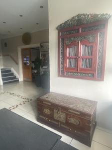 a large wooden chest sitting in the corner of a room at Park Crescent Hotel in Manchester