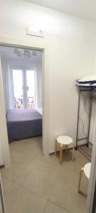a bedroom with a bed and a table and a stool at Alba b&b in Polignano a Mare