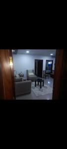 a living room with a couch and a table at Premium apartment in Mansoura