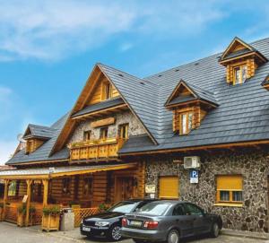 a car parked in front of a house at Hotel Koliba in Senec