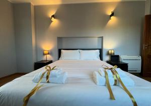 a bedroom with a large white bed with two towels at Maison Linda - Ponte Milvio Apartment in Rome