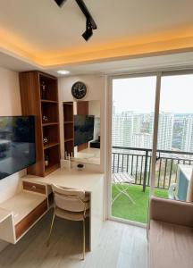 a home office with a desk and a large window at Near AYALA-Charming Studio with Balcony&Great View in Cebu City