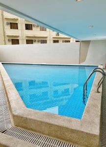 a swimming pool in the middle of a building at Near AYALA-Charming Studio with Balcony&Great View in Cebu City