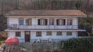 a white house with a balcony on top of it at Casa belvedere in Sanfront