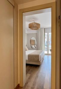 a bedroom with a bed and a mirror at Hotel Windsor in Tossa de Mar