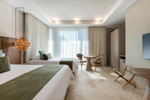Ένα ή περισσότερα κρεβάτια σε δωμάτιο στο Oz Hotel Cartagena