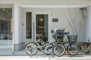 three bikes parked in front of a building at ホテルトーイン京都 in Kyoto