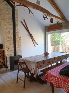 a dining room with a table and a fireplace at Maison de 3 chambres avec jardin clos a Chateauneuf d'Oze 