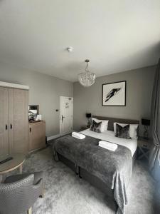 a bedroom with a large bed and a table at One Warwick Park Hotel in Royal Tunbridge Wells