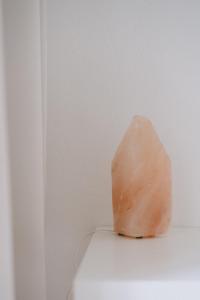 a large pink rock sitting on top of a white wall at Alfreda in Sokołowsko