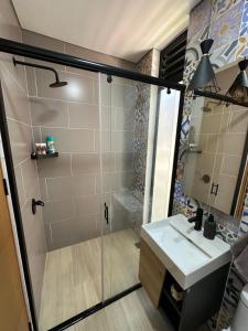 a bathroom with a shower and a sink at Villa Luz in Villavicencio