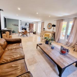 a living room with a couch and a table at Villa OASIS en Provence Luberon Pierrevert in Pierrevert