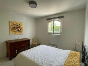a bedroom with a bed and a window at Maison cosy en bordure du golf. in Saint-Raphaël