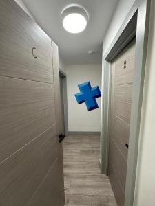 a hallway with a blue cross on the wall at Inviting Studio Flat at Lewisham Way SE14 London in London