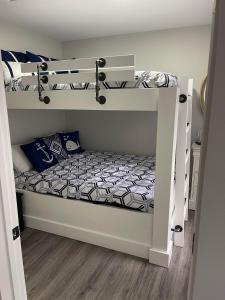 a bedroom with two bunk beds in a room at Eagle's Nest Cottage - Lake Anna Waterfront in Bumpass