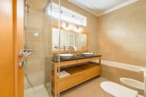 a bathroom with a sink and a shower at By the Beach in Praia d'el Rey in Óbidos +9 photos