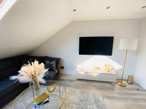 a living room with a couch and a table at Apartment in Stepney Green in London