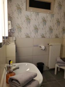 a bathroom with a sink and a tv on the wall at Privatpension Waldbröl in Waldbröl
