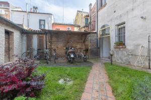 a house with two bikes parked next to a building at Coperta Retreat! Near Estense Castle in Ferrara