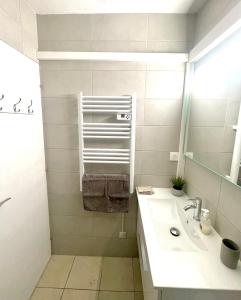 a bathroom with a sink and a mirror at Appart CLIM , WIFI, PLAGE 200 mètres in Argelès-sur-Mer