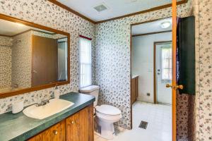 a bathroom with a toilet and a sink and a mirror at Valley View Lodge Rural Home in Bridgeport! in Bridgeport +18 photos