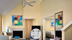 a living room with a ceiling fan and a bedroom at Sonesta ES Suites Cleveland Airport in Middleburg Heights