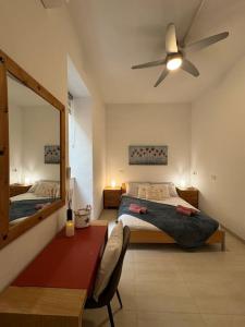 a bedroom with a bed and a mirror and a table at Modern Seaview-2 min from Beach in Sliema