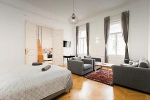 um quarto com uma cama e uma sala de estar em BudapeStayz - Izabella Studios em Budapeste