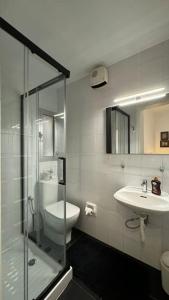 a bathroom with a shower and a sink and a toilet at Modern Seaview-2 min from Beach in Sliema