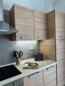 a kitchen with wooden cabinets and a counter top at Modern Seaview-2 min from Beach in Sliema +12 photos