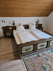 a bedroom with two beds and a wooden ceiling at Am Wehrastrand App 4 in Todtmoos