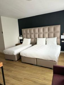 duas camas sentadas uma ao lado da outra num quarto em MA Airport Hotel em Hoofddorp