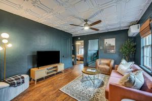 a living room with a couch and a flat screen tv at Chic Elizabethtown Apartment Walk to Downtown! in Elizabethtown