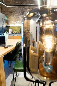 an office with a reflection of a table and chairs at Black Swan Hostel Granada in Granada