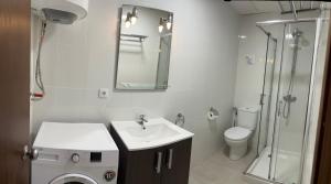 a bathroom with a sink and a toilet and a mirror at Apartamentos Miradores in Miami Platja