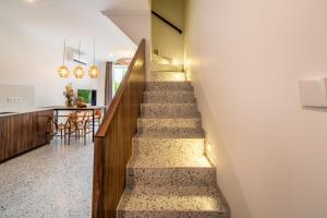 a staircase leading to the kitchen and dining room of a house at Sunny Village Berawa in Canggu