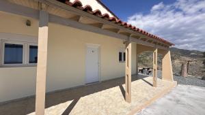a view of a house with a patio at Sfinias Apartments in Kali Limenes