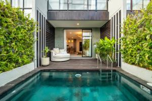 an indoor pool in the backyard of a house at Sunny Village Berawa in Canggu