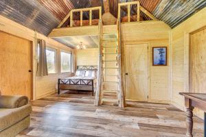 a wooden cabin with a ladder in a room with a bed at Waterfront Marksville Studio with Dock! in Marksville