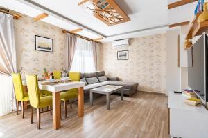 a living room with a couch and a table and chairs at Loi Suite in Antalya