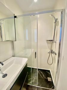 a bathroom with a shower and a sink at Bianco a Nero Mykonos in Mikonos