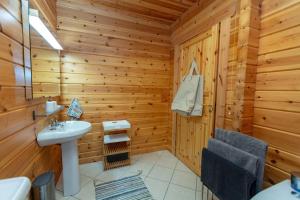 un bagno con lavandino in una baita di tronchi di Large Luxury Log Cabin Getaway a Ballyconnell
