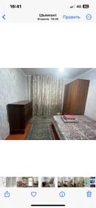 uma imagem de um quarto com uma cama e uma cómoda em Квартира em Shymkent