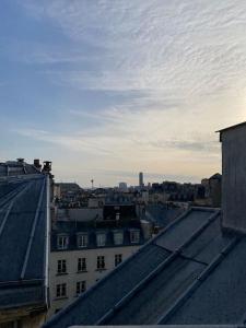 a view of a city from the roofs of buildings at Central Duplex with Panoramic Views over Paris in Paris