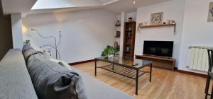 uma sala de estar com um sofá e uma mesa de centro em El 15 de Rivero, En pleno centro em Avilés