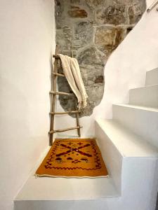 a ladder with a rug on the side of a stairs at LG LAKE - Boutique apartments and rooms - in Brienno