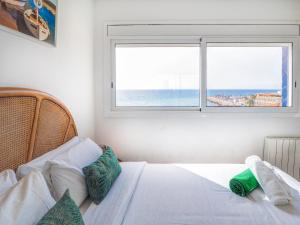A bed or beds in a room at Marina Duplex by Hello Homes Sitges